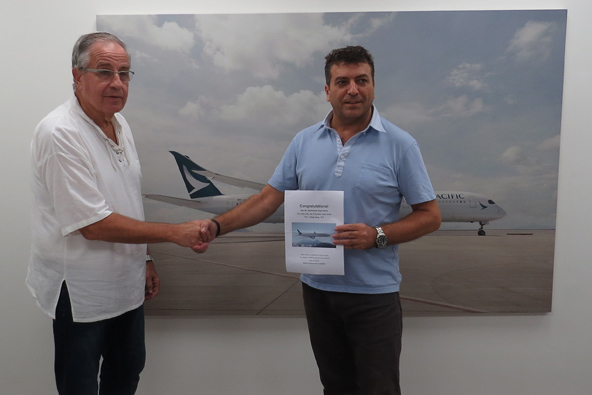 שי להב, מנהל המכירות של קתאי פסיפיק בישראל (מימין), מעניק את כרטיס הטיסה לאודי זמלרוט