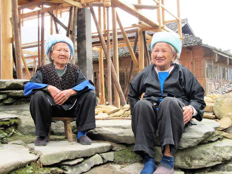 בנות גואנג, המיעוט הקטן הגדול ביותר בסין - יושבות ומפטפטות במרכז הכפר
