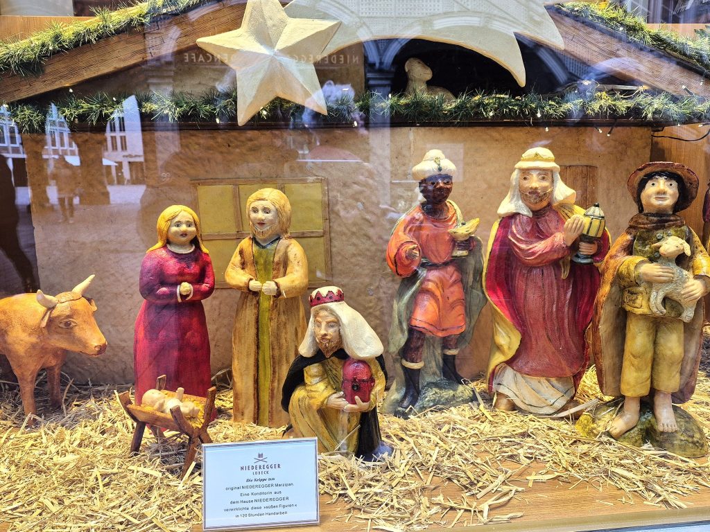 בחלון הראווה התנוססה תערוכת כריסמס עם כל הקדושים, האורווה ועדר הצאן. הכל עשוי מרציפן